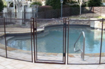 Pool safety gate installed in a paver pool deck, bronze color pool fence in Tampa