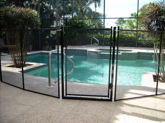 A pool safety fence with gate in Tampa FL www.tampapoolfence.com